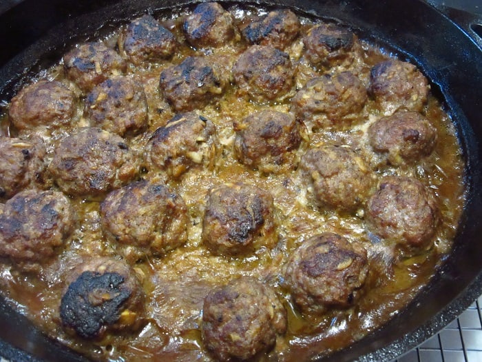 Pork Meatballs with Apples and Onions in a cast iron skillet after baking.