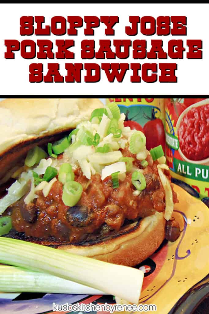 A vertical closeup image along with a title text overlay graphic of a Sloppy Jose Pork Sausage Sandwich on a bun with black beans and scallions.