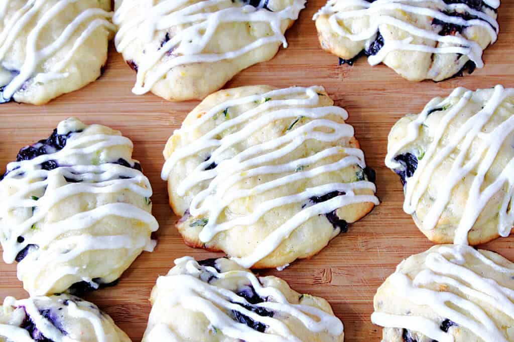 A super closeup overhead photo of an iced Zucchini Ricotta Cookie on a wooden tray.