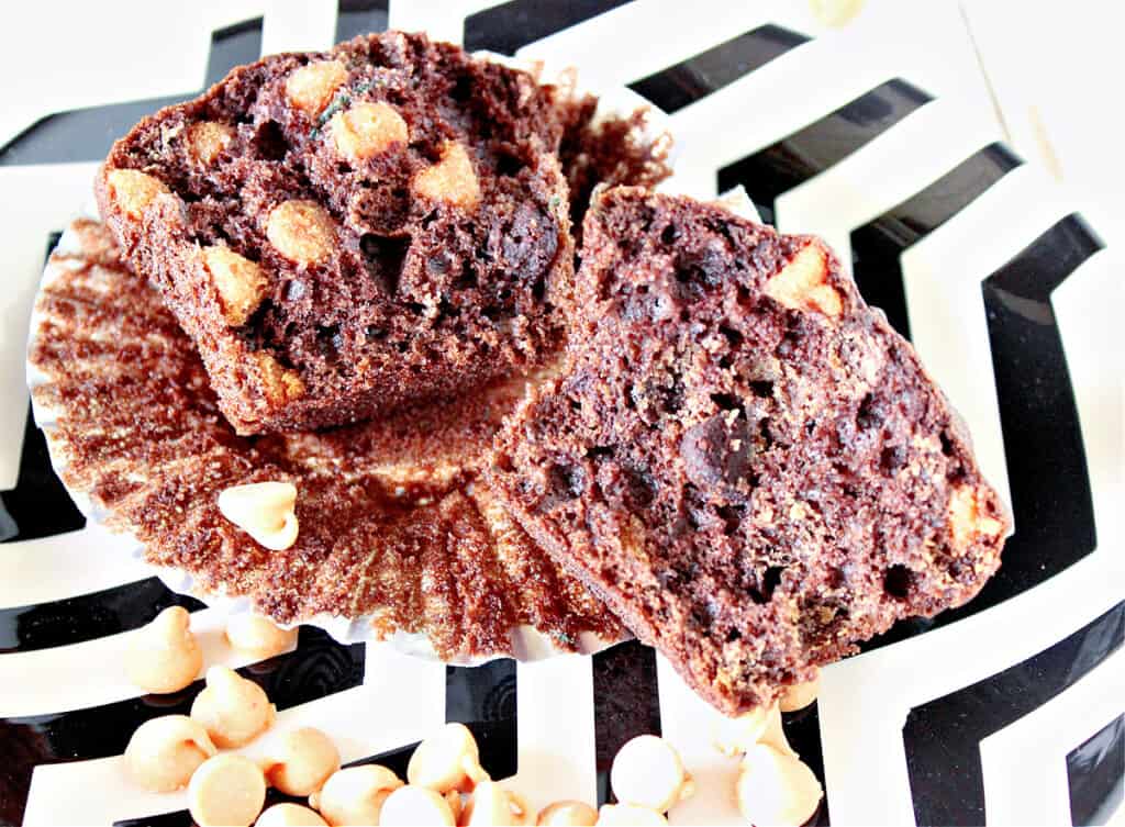 A closeup of the inside of a Chocolate Zucchini Muffin with Peanut Butter cut in half on a black and white plate.