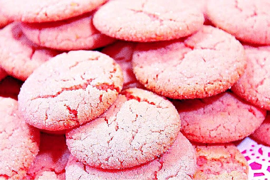 A super closeup horizontal photo of Pink Lemonade Cookies in a pile.