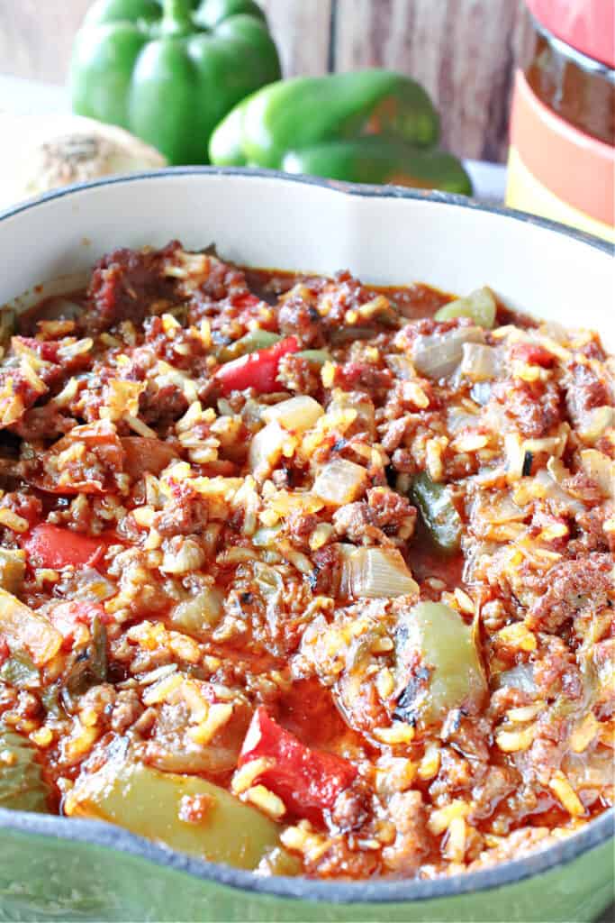 A closeup vertical image of a big pot of Stuffed Green Pepper Stew with ground beef, onion, and rice.