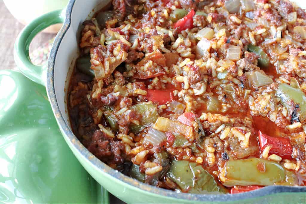 An overhead horizontal closeup photo of pot of Stuffed Green Pepper Stew with rice, ground beef, and green peppers.