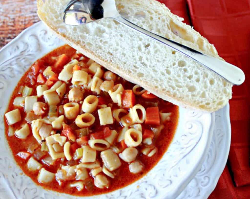 An offset horizontal photo of a big bowl filled with Tuscan Pasta Soup with chickpeas, carrots, celery, and pasta.