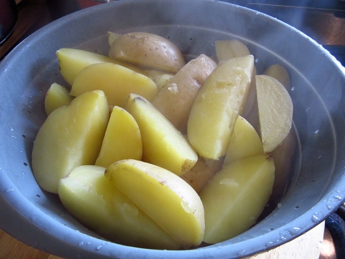 Hot potatoes in a colander after cooking.