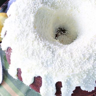 Ginger Lemon Buttercream Frosting on a bundt cake with white non pareils