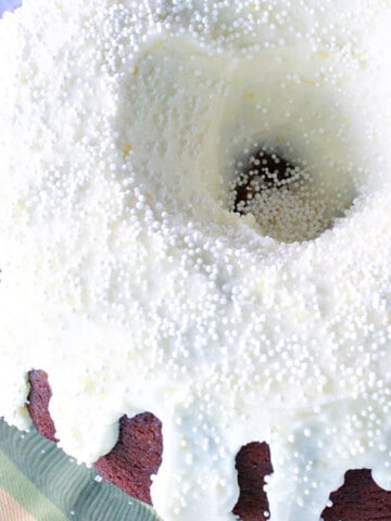 Ginger Lemon Buttercream Frosting on a bundt cake with white non pareils