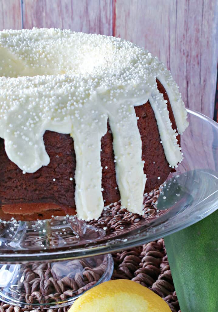 A bundt cake covered with a delicious Ginger Lemon Buttercream Frosting and white nonpareils.