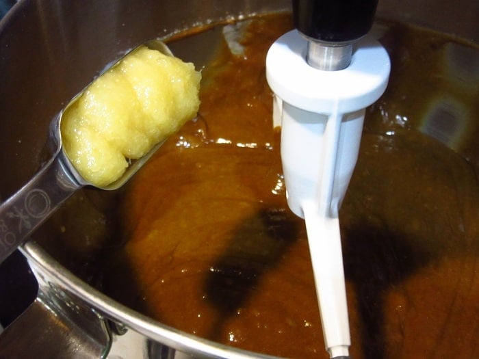 Ginger paste being added to a bowl.