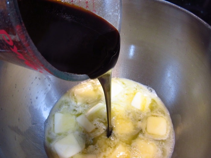 Molasses being added to a bowl.