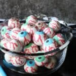 A glass bowl filled with colorful Gumball Eyeballs.