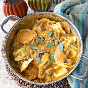 Ravioli with Pumpkin Vodka Sauce in a silver skillet with sage.