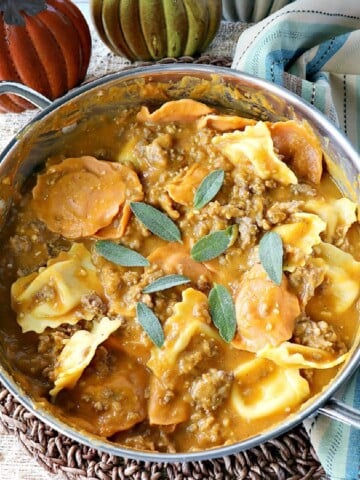 Ravioli with Pumpkin Vodka Sauce in a silver skillet with sage.