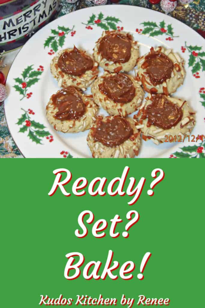 A holly berry plate filled with Caramel Pretzel Thumbprint Cookies along with a ready, set, bake text graphic.