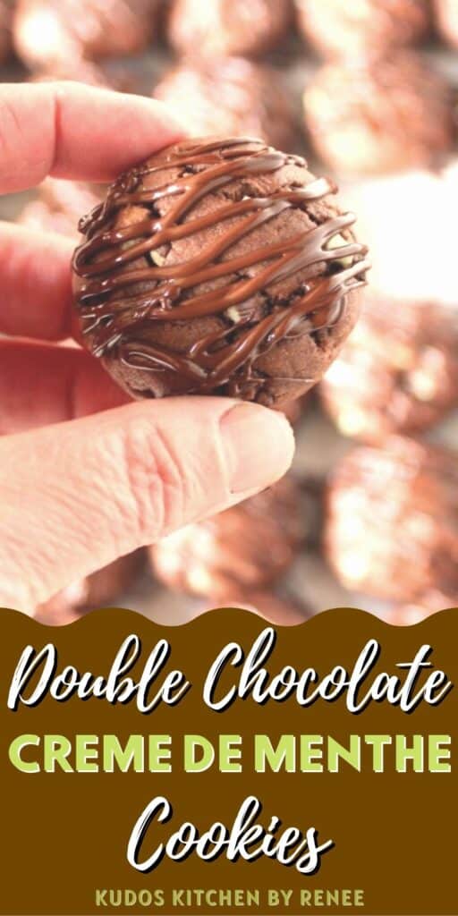 A vertical closeup of a hand holding a Chocolate Creme de Menthe Cookies along with a title text graphic on the bottom of the photo.