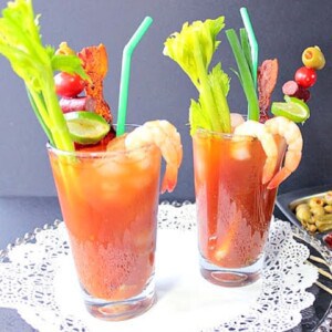 Two Bacon Bloody Mary's with celery, shrimp, and bacon.