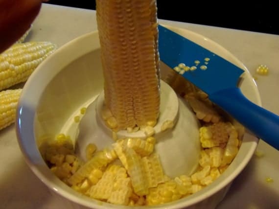 An ear of corn in a bowl.