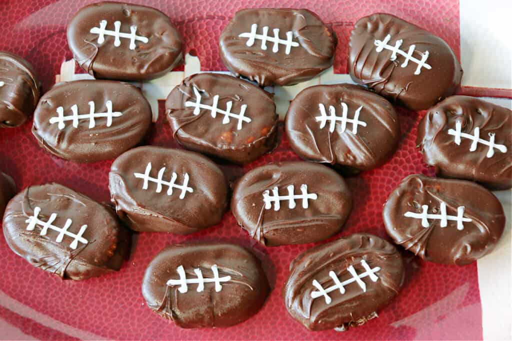 An overhead photo of Peanut Butter and Jelly Chocolate Covered Football Crackers on a football tray.