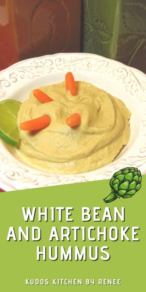 A vertical closeup of a bowl of White Bean and Artichoke Hummus along with a title text overlay graphic.