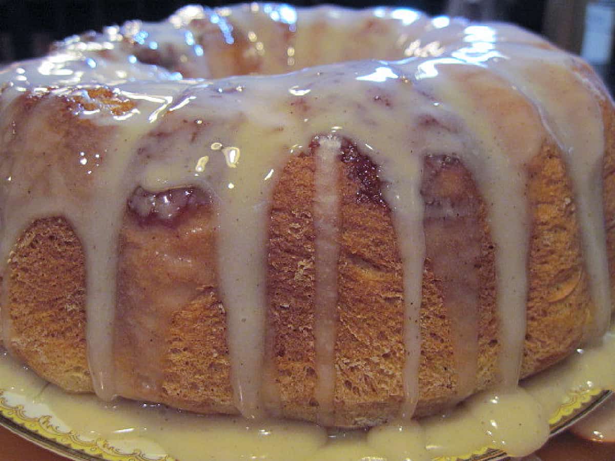 A Cinnamon Roll Cake topped with a white glaze icing.