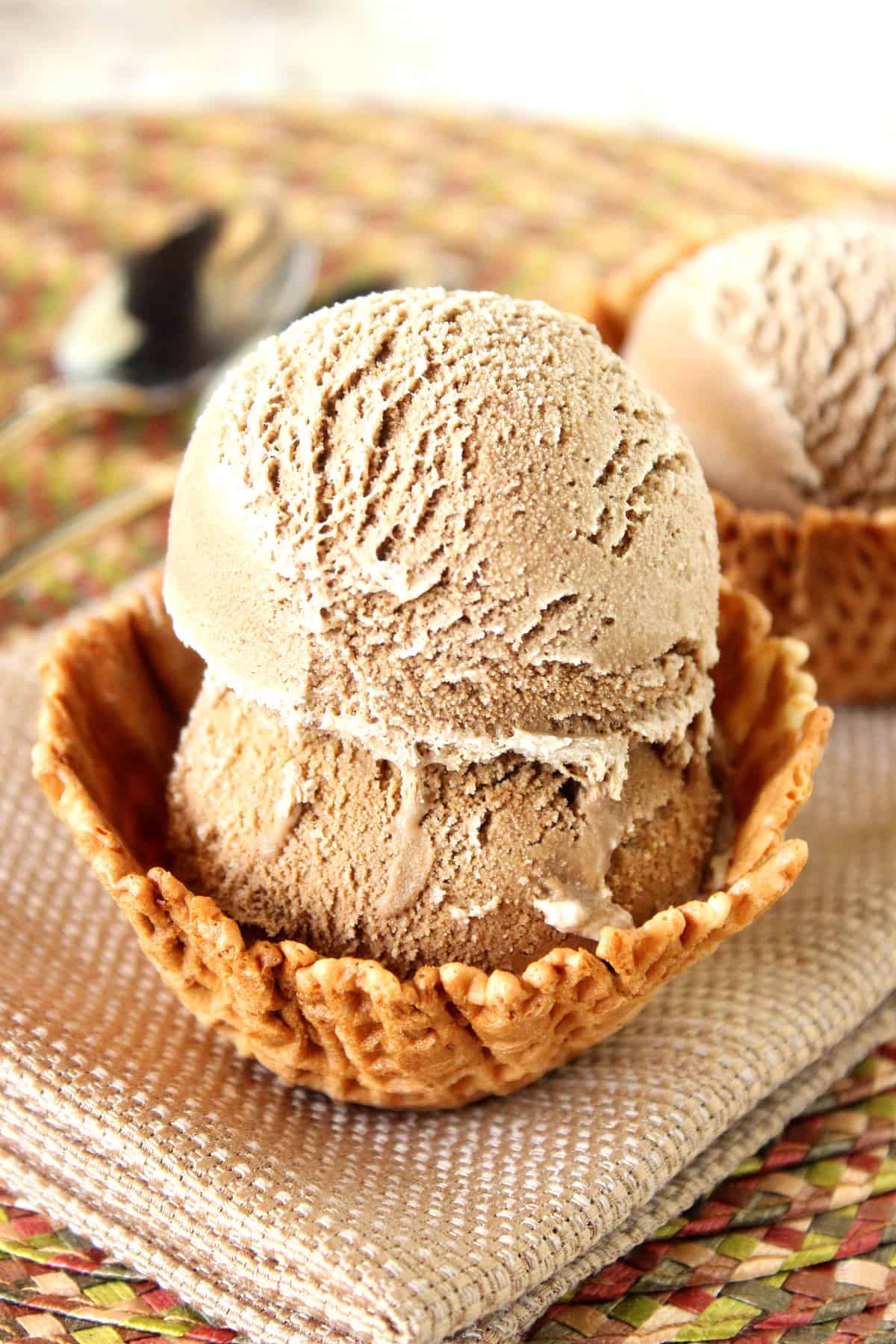 Two scoops of Root Beer Ice Cream in a waffle cone bowl.