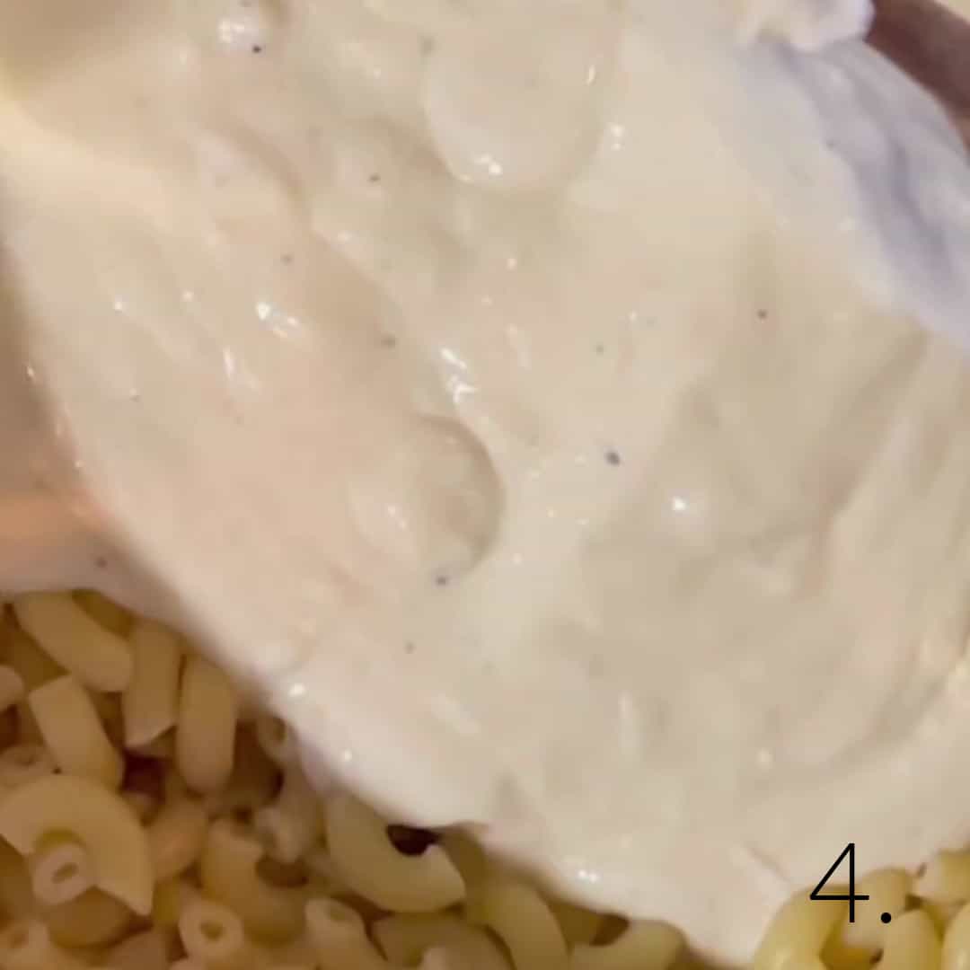 Alfredo sauce poured over macaroni.
