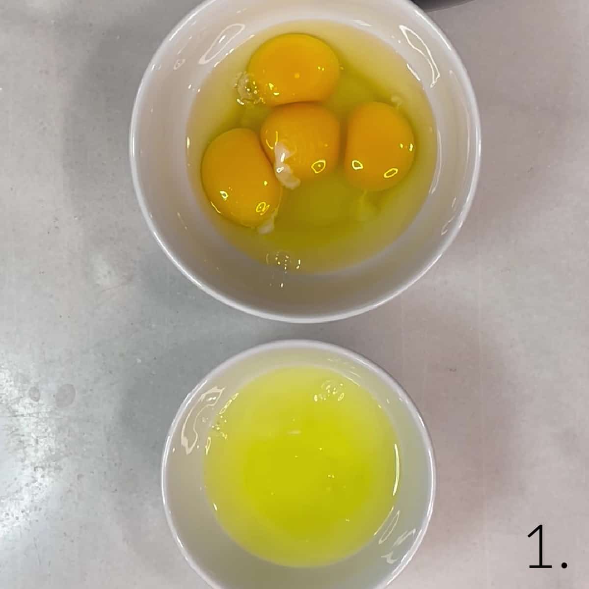 Egg yolks and egg whites in two separate dishes/