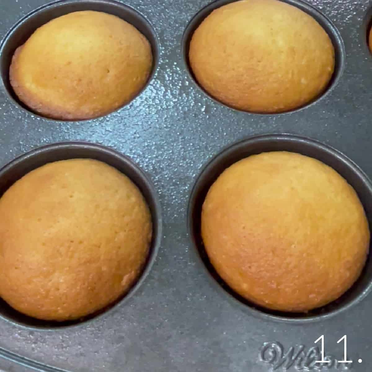 Golden baked cupcakes in a cupcake tin.