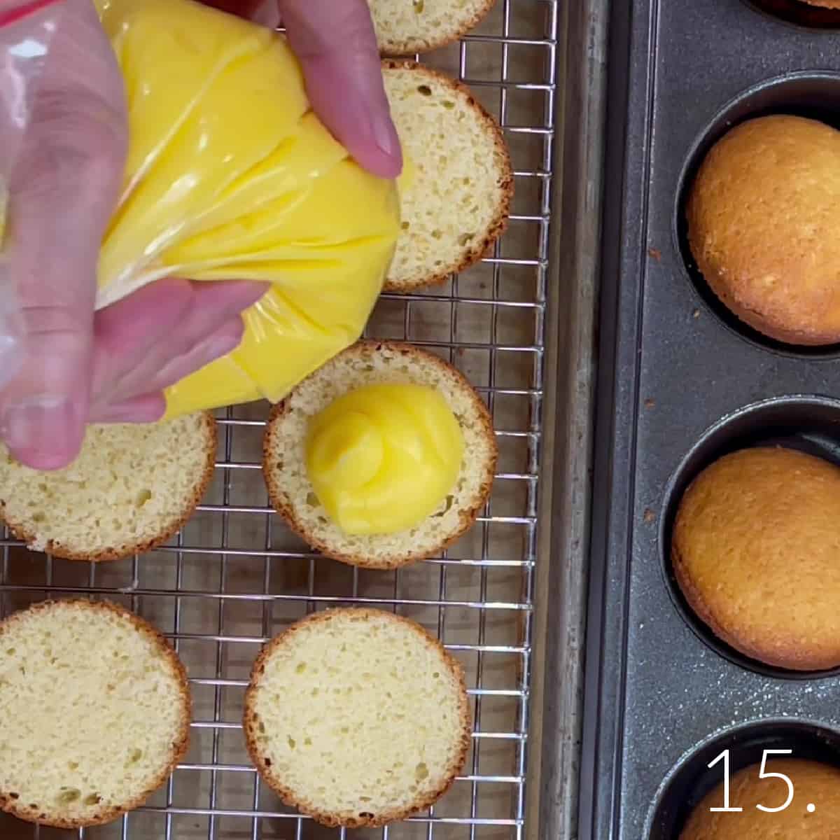 Vanilla pudding in a plastic bag being piped onto one side of a Boston Cream Cupcake.