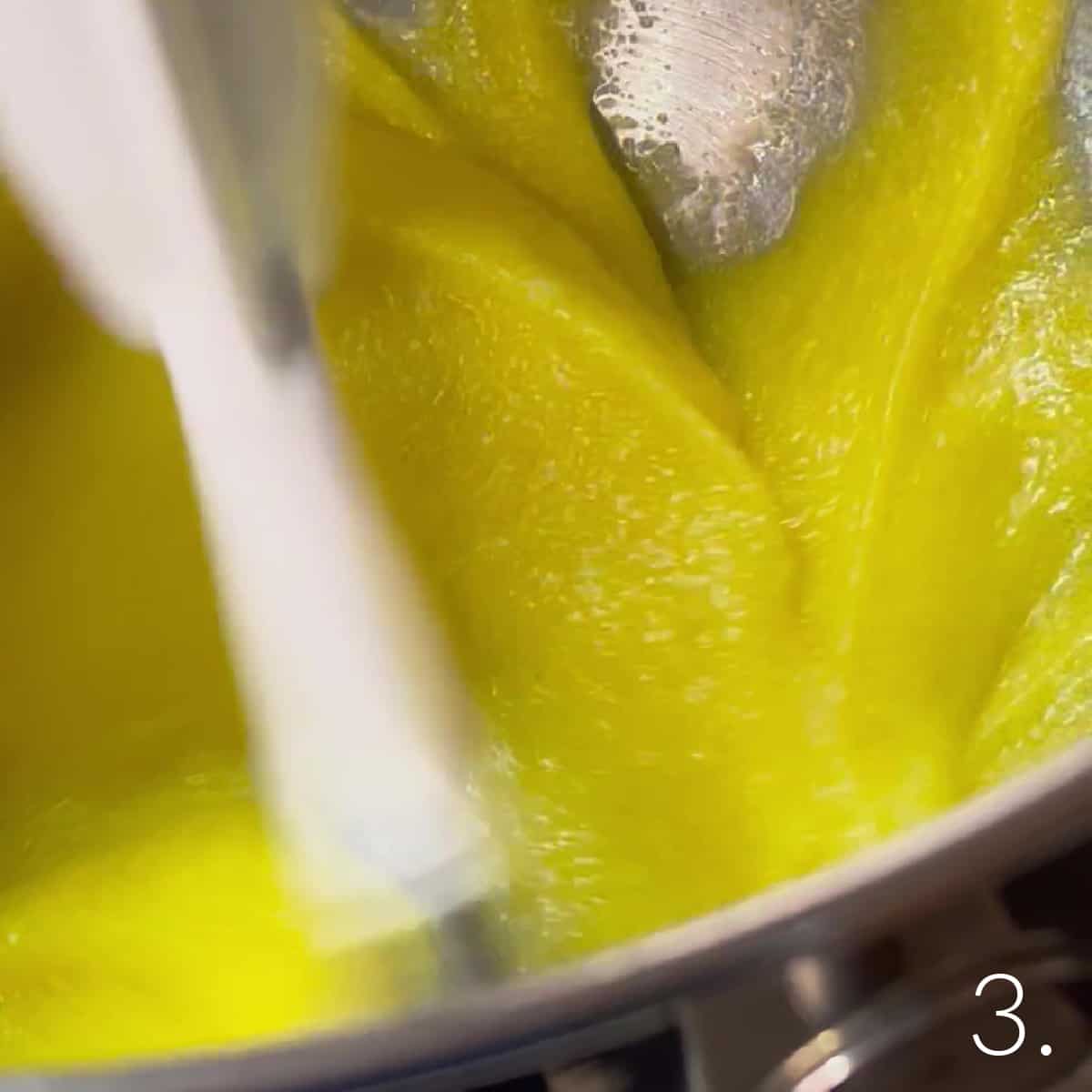 A stand mixer creaming together eggs and sugar for Boston Cream Cupcakes.