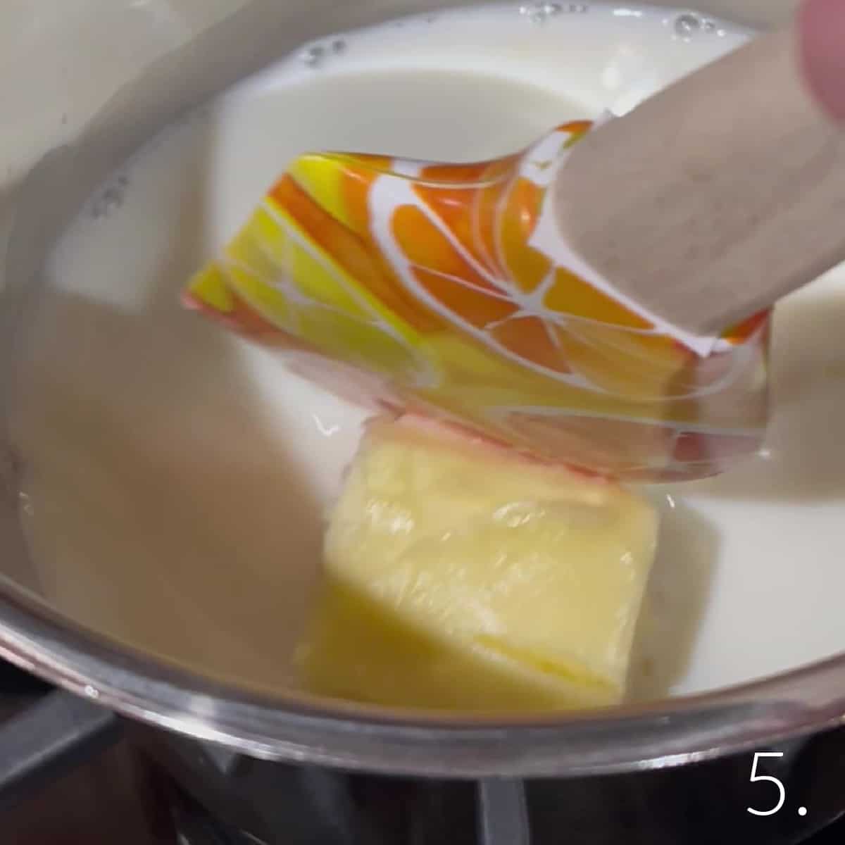 Butter and milk in a saucepan for making Boston Cream Cupcakes.