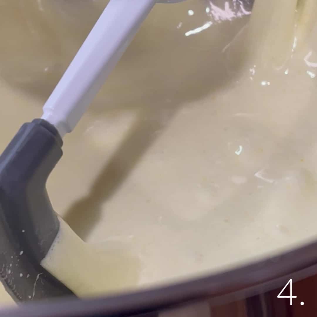 Butter and sugar combined in a mixing bowl for cupcake batter.