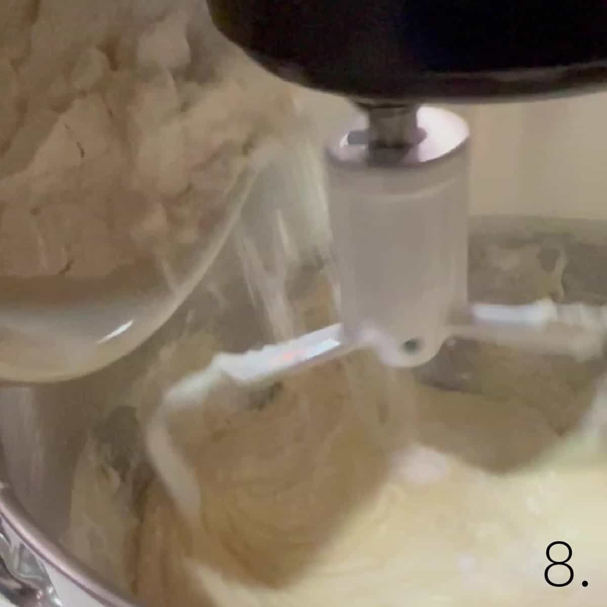 Flour being poured into cupcake batter for Boston Cream Cupcakes.