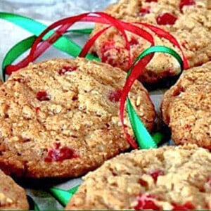 A bunch of Cinnamon Oatmeal Cookies surrounded with red and green ribbon.