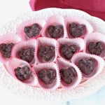 A pretty tray filled with Chocolate Covered Dried Cherry Clusters made into heart shapes.