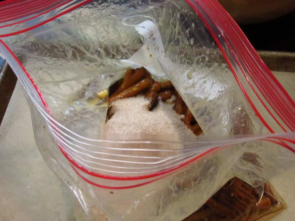 Pretzel sticks in a bag along with cinnamon and sugar.