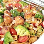 A colorful serving of Linguine with Caramelized Scallops along with broccoli and tomatoes.