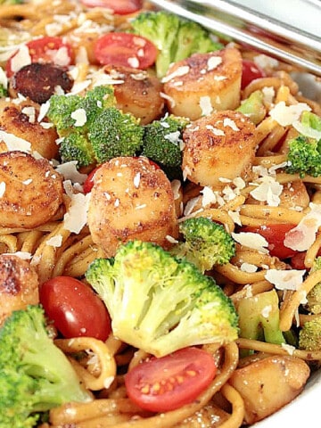 A colorful serving of Linguine with Caramelized Scallops along with broccoli and tomatoes.
