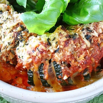 An overhead photo of a Hasselback Zucchini with Pepperoni and cheese in a baking dish.