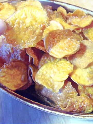 A brown bowl filled with Homemade Sweet Potato Chips.