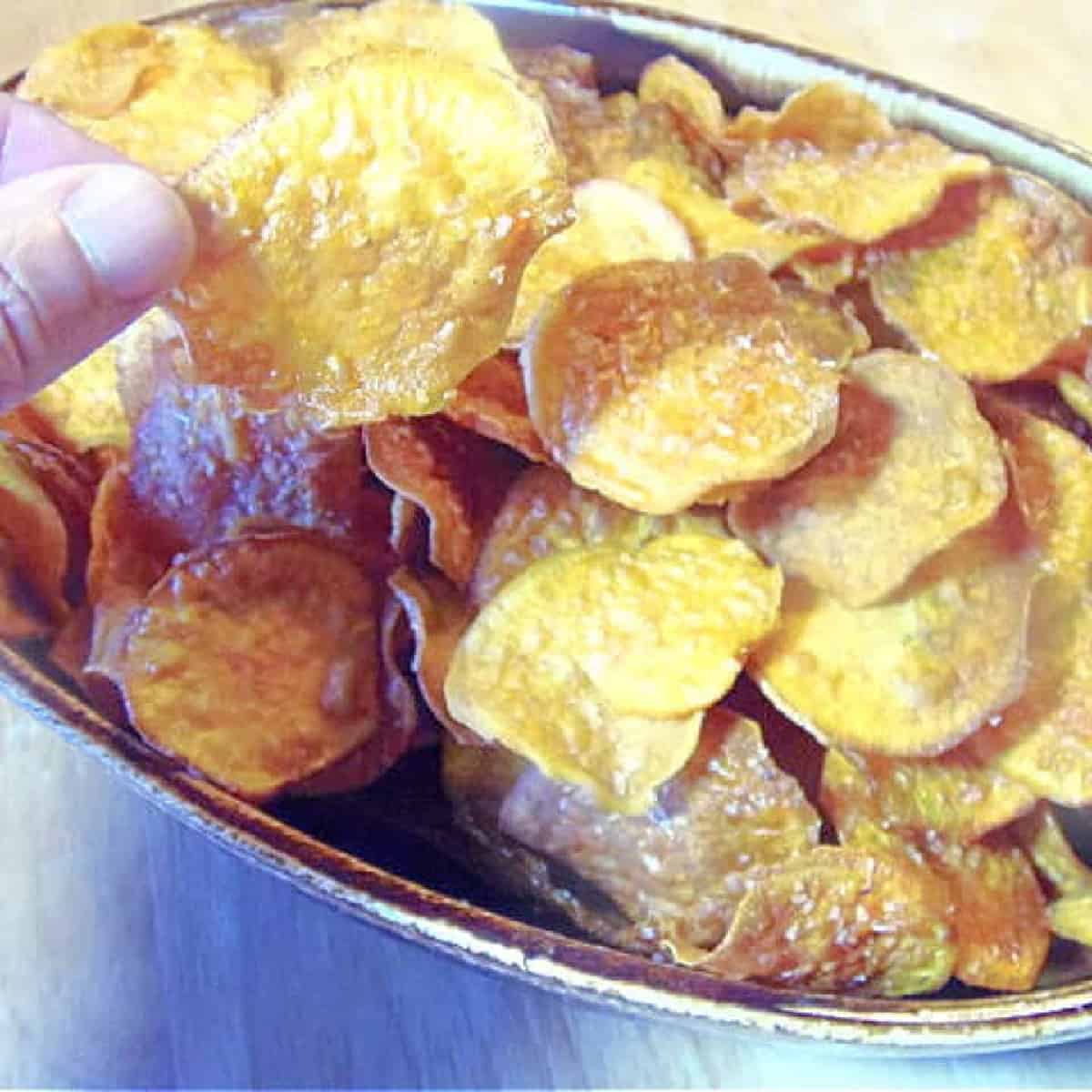 Roasted Sweet Potato and Wilk Rice Chowder A brown bowl filled with Homemade Sweet Potato Chips.