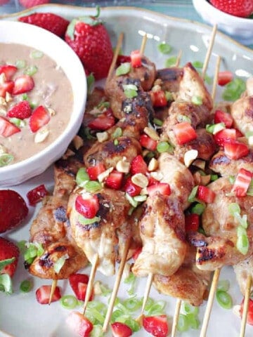 Colorful Chicken with Strawberry Satay sauce with green onion and chopped strawberries.