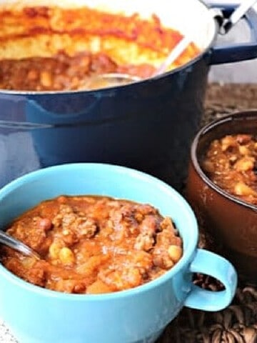 A soup pot along with two bowls filled with Spaghetti Squash Chili.