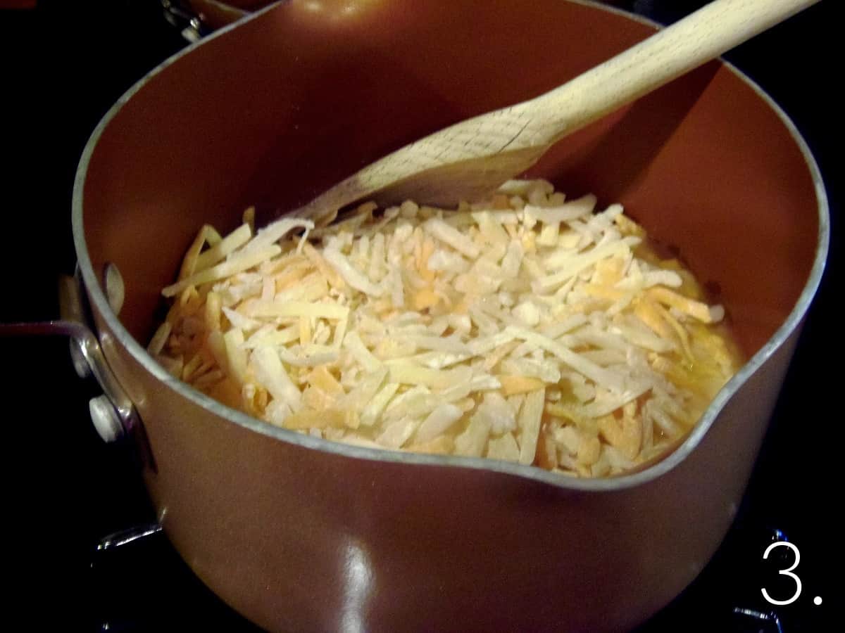 Shredded cheeses in a saucepan.