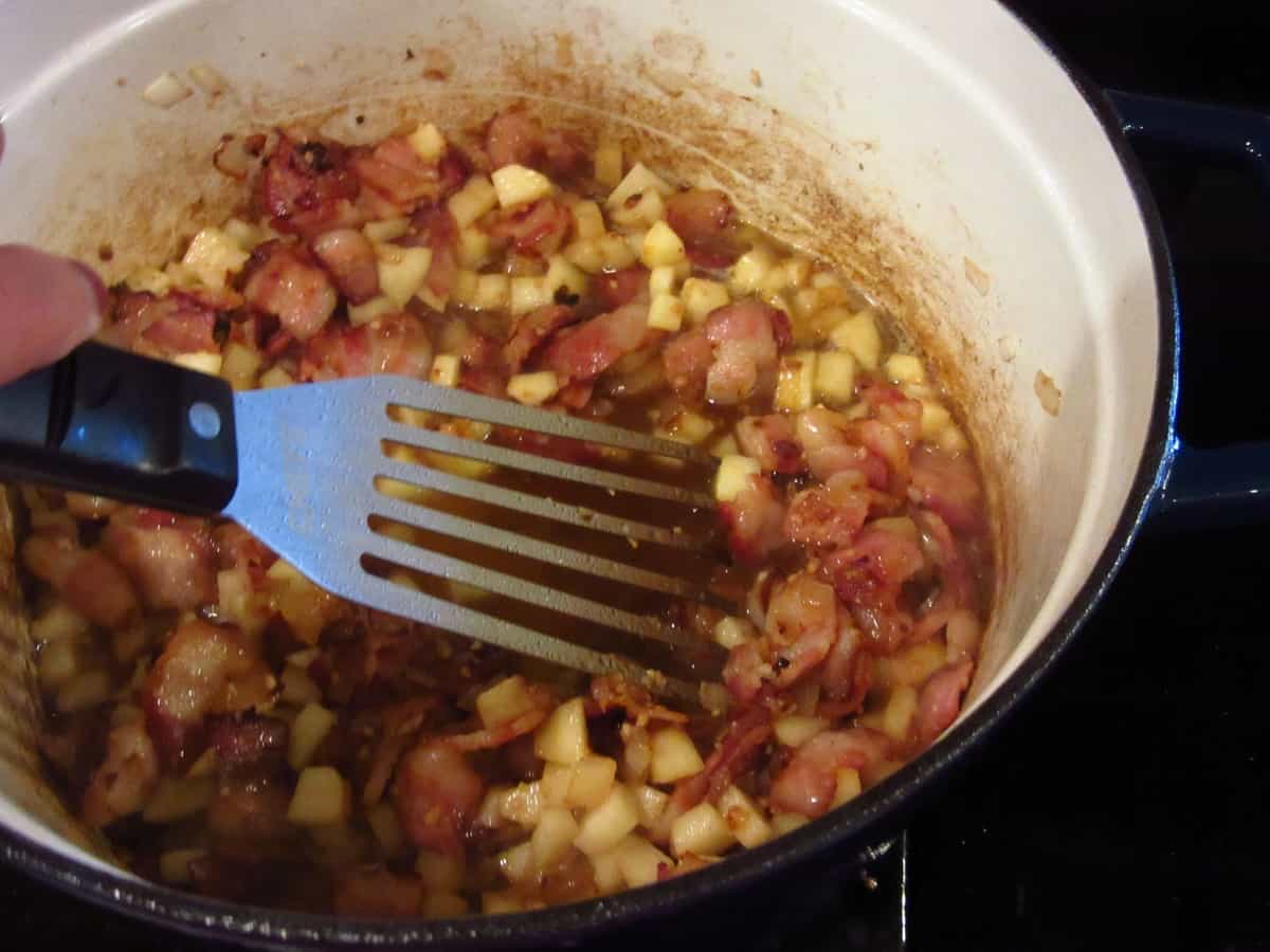 Scraping up the fond from the bottom of the pot while making apple corn chowder.