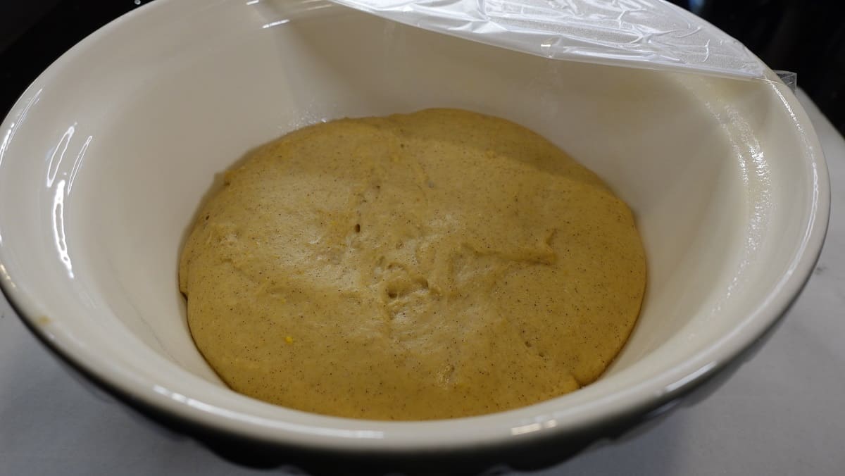 Yeast dough for making glazed apple cider donuts that has doubled in volume.