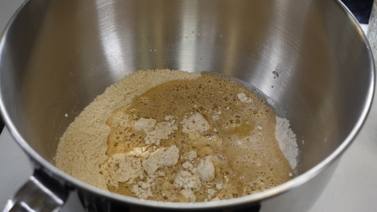 Flour and yeast mixture along with apple cider and butter mixture in a large bowl.