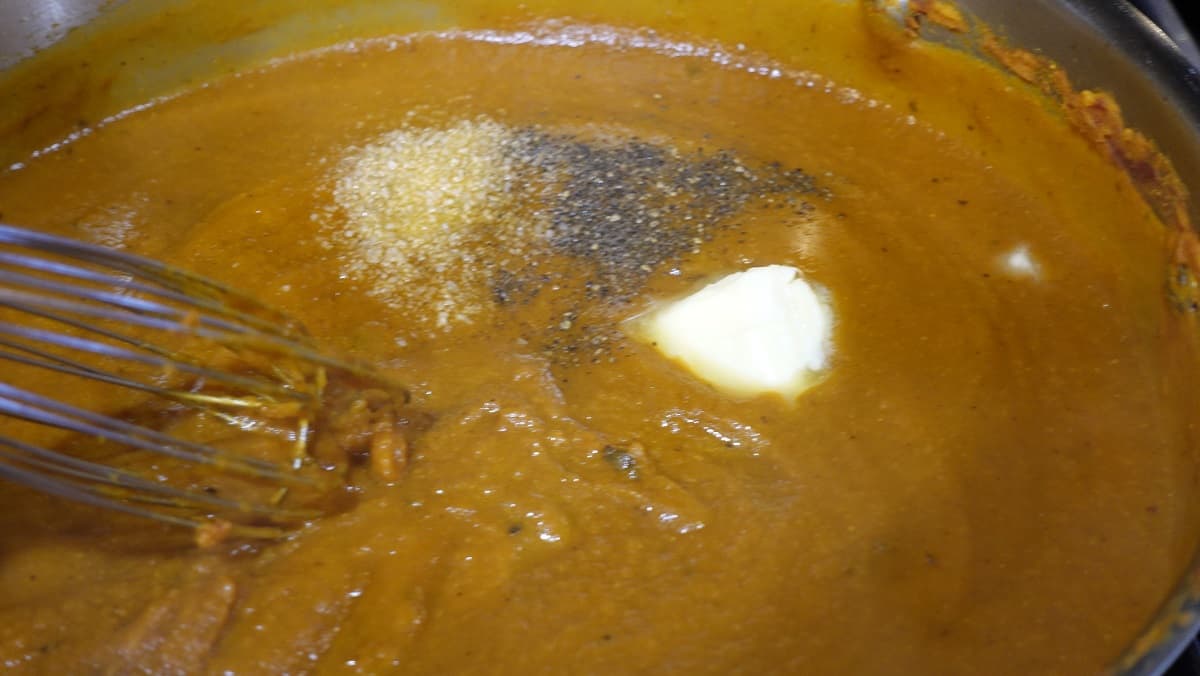 Salt, pepper, and butter just added to a pumpkin curry sauce.