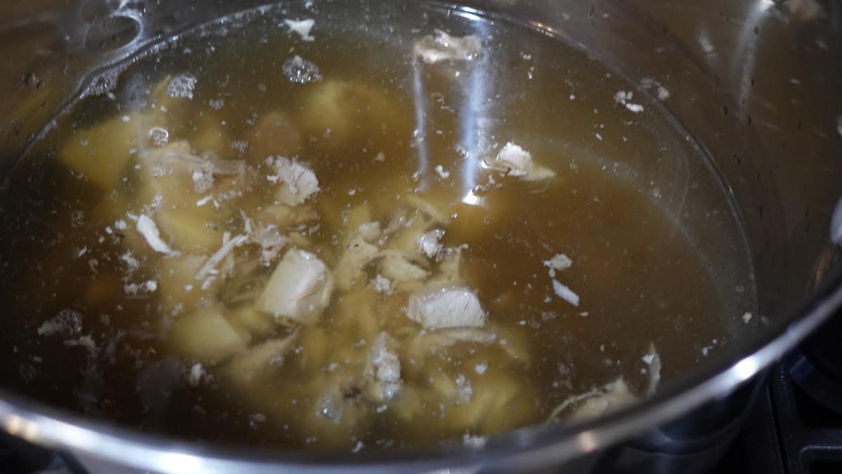 Leftover turkey pieces added to a stock to make soup.