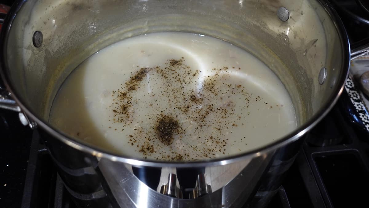 Creamy Turkey Potato Soup in a saucepan with black pepper.
